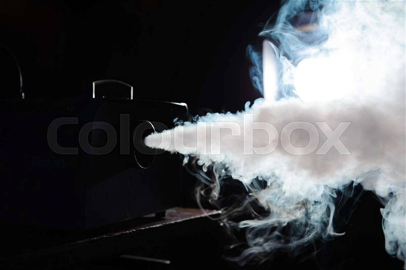 Smoke machine in action. Smoke in the dark, stock photo