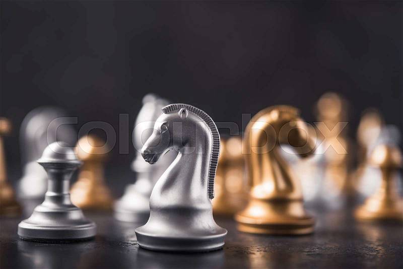 Chess knight horse on the chessboard, stone background. selective focus, stock photo