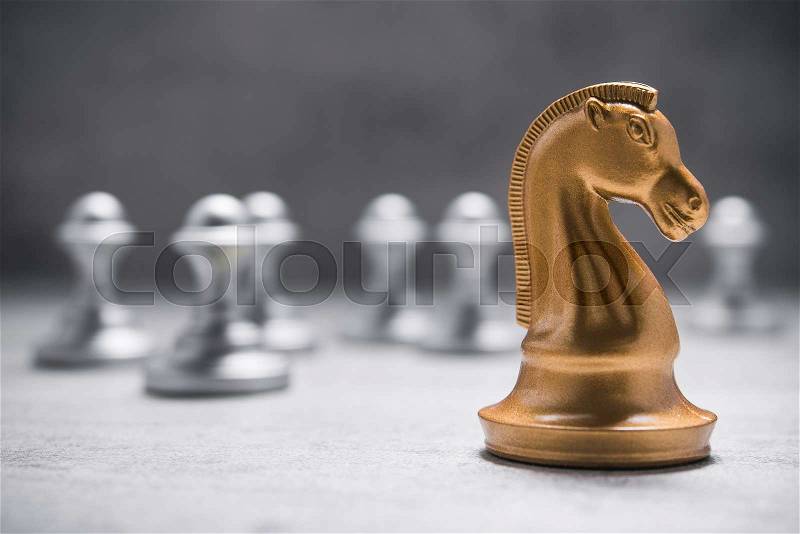 Chess knight horse on the chessboard, stone background, stock photo