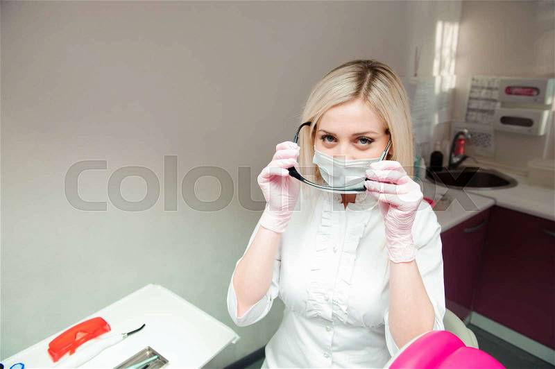 Female doctor wearing a face mask and goggles, stock photo