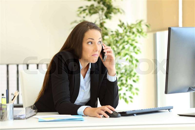Confused office worker calling on phone checking computer content, stock photo