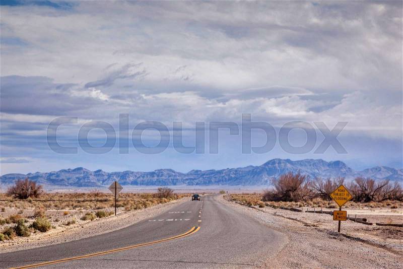 Road through desert area near the California-Nevada border, Death Valley Junction, California, stock photo