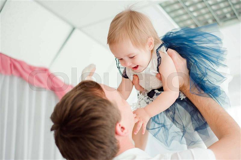 Dad hugging and kissing his little daughter, stock photo