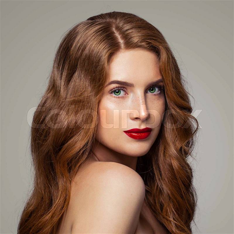 Redhead girl with green eyes and ginger hair studio portrait, stock photo