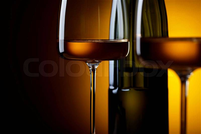 Glasses and bottle of wine on a yellow background. Selective focus , stock photo