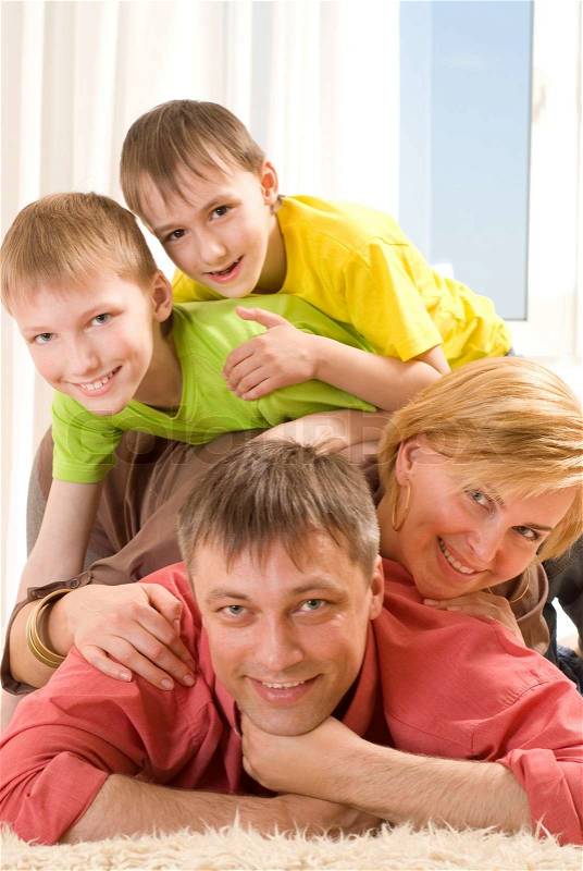 Happy family four on a light, stock photo