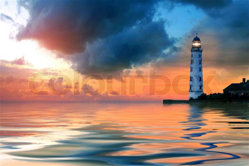 Beautiful nightly seascape with lighthouse and moody sky at the sunset, stock photo