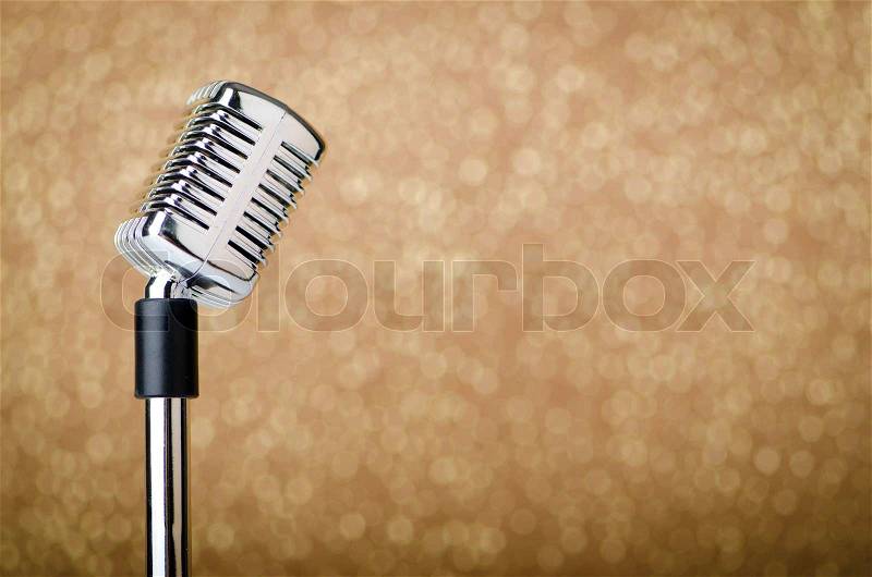 Old vintage microphone on background, stock photo