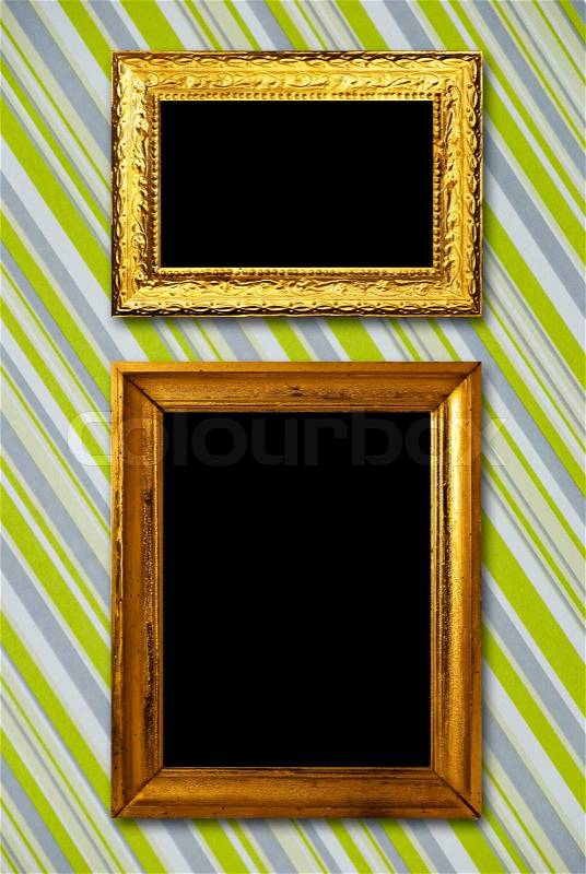 Gold frame on striped vintage wallpaper background, stock photo