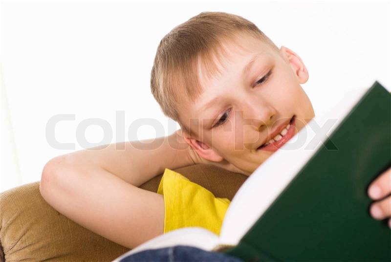 Boy reading a book, stock photo