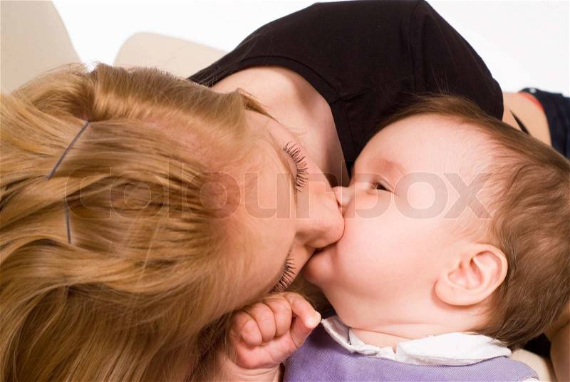 Mom kisses her baby, stock photo
