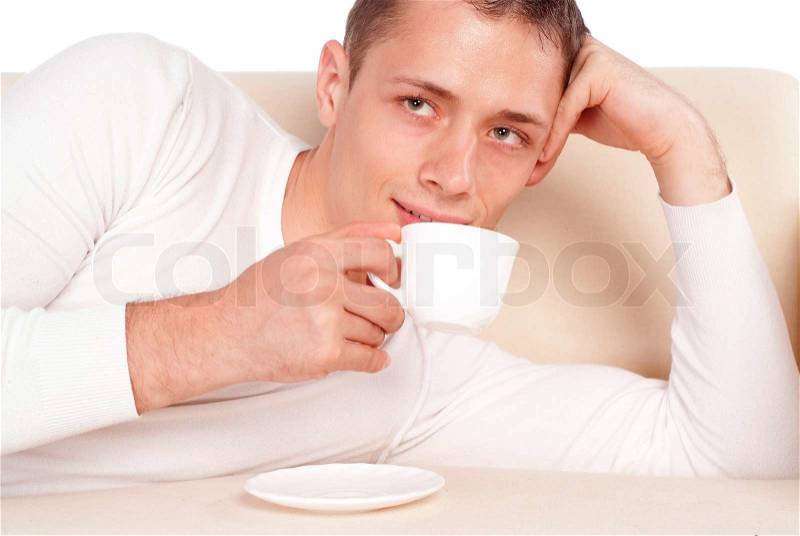Guy with cup on sofa, stock photo