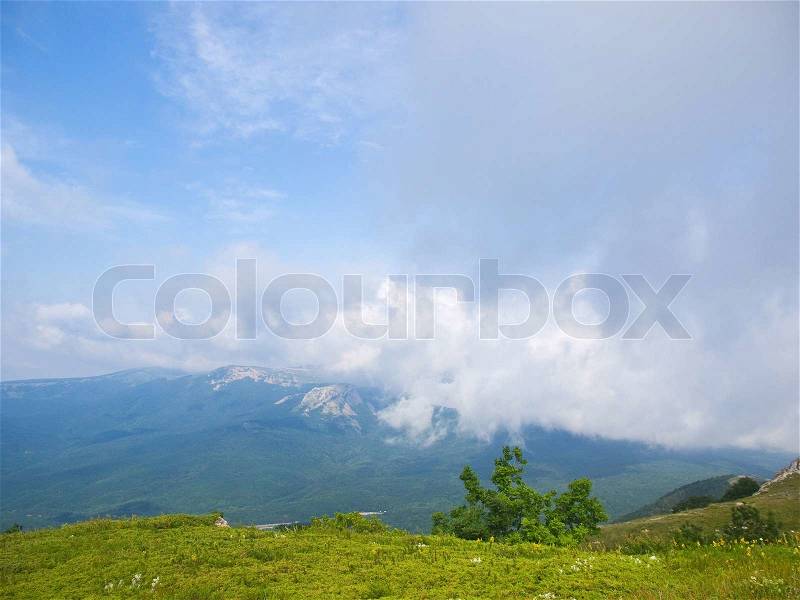 Peaceful and calm place high in the mountains beneath the blue sky, stock photo