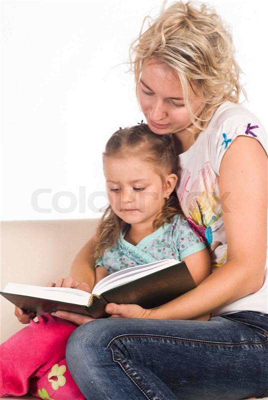 Mom and her daughter read a book, stock photo