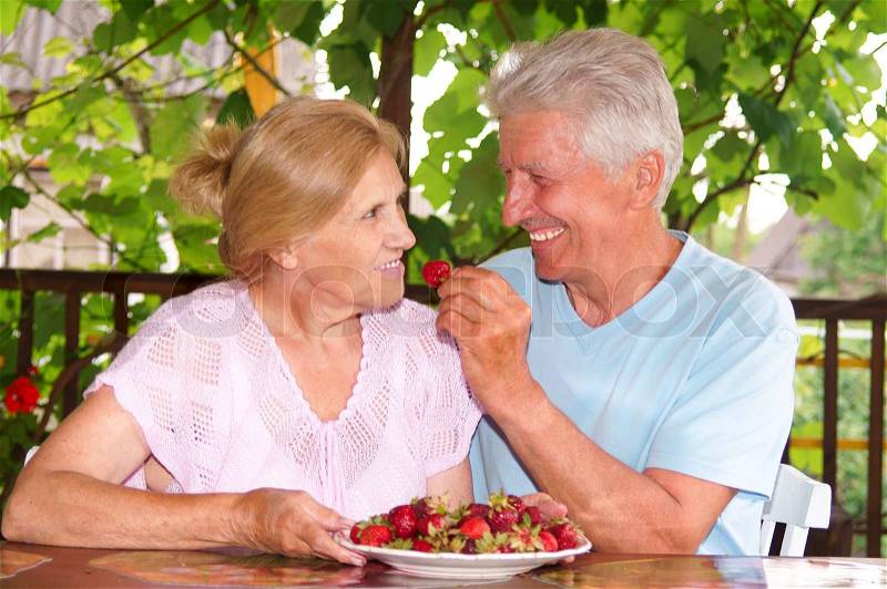 Old couple eating, stock photo