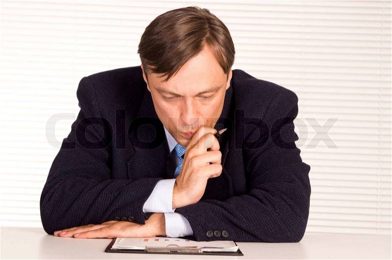 Businessman at table, stock photo