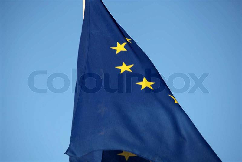 The EU flag against blue sky, stock photo