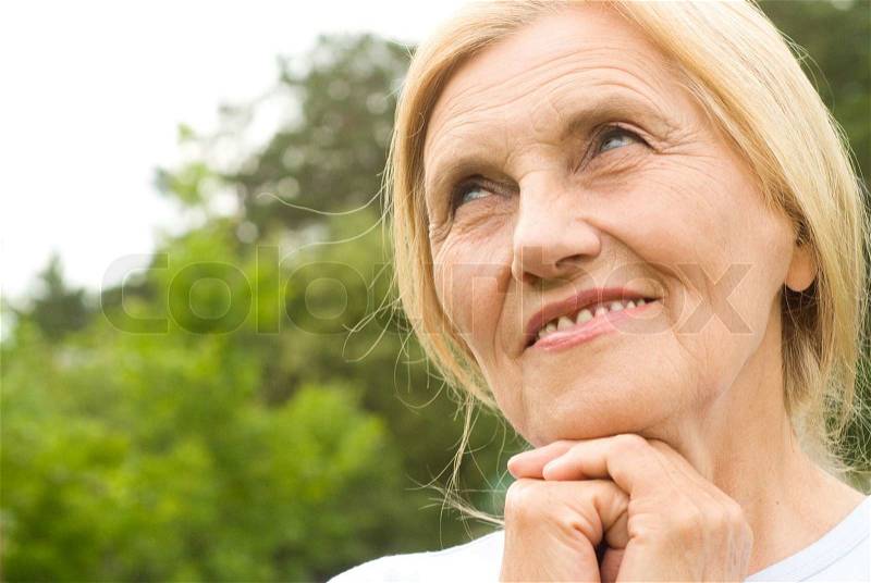 Old nice woman outside, stock photo