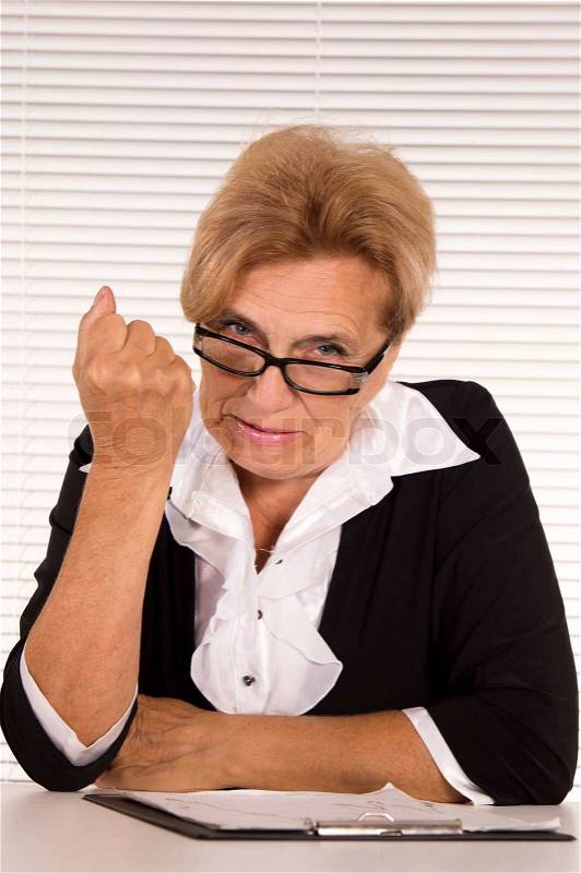 Smart old woman at office, stock photo