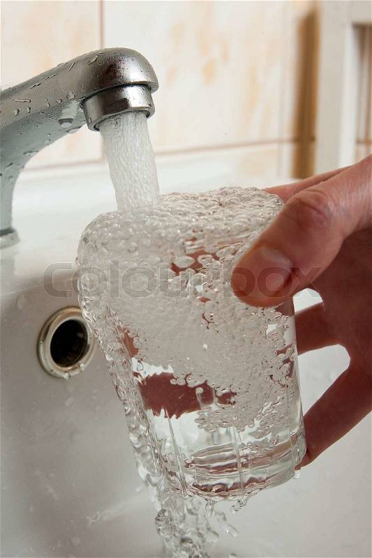 Filling glass of water, stock photo