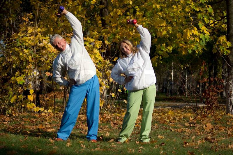 Old people with dumb bells, stock photo