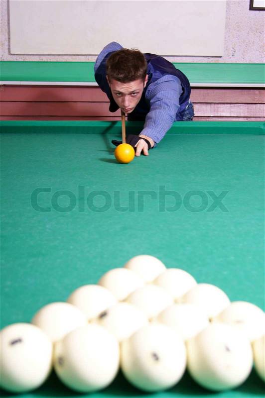 Man playing billiards, stock photo