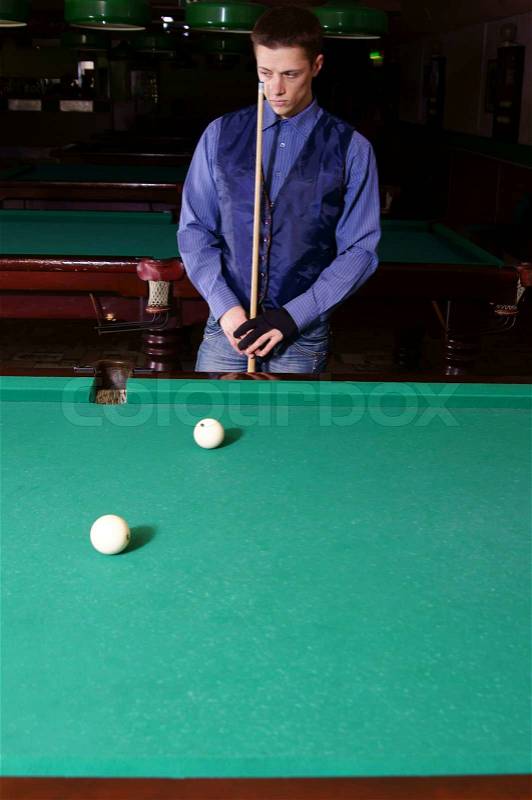 Guy playing billiards, stock photo