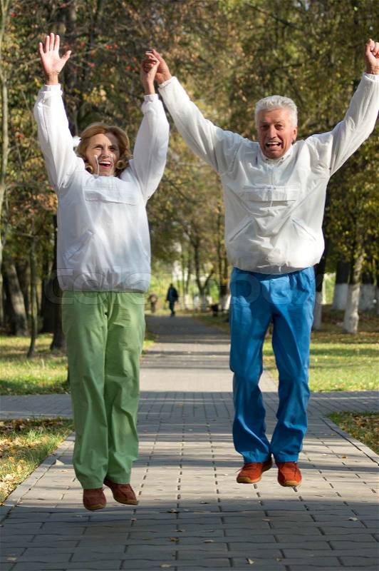 Active old people jump in park, stock photo