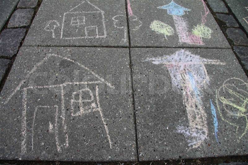 Four children chalk drawings on the tiles, stock photo