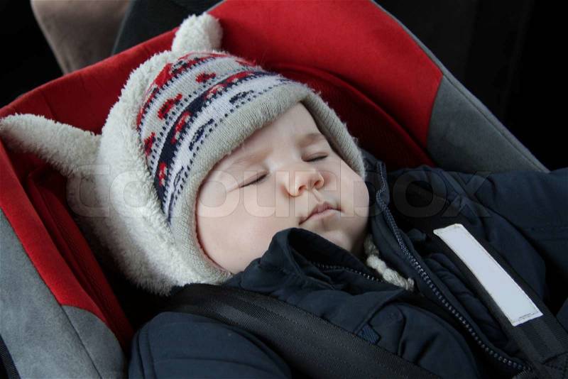 Baby sleeping in car seat, stock photo