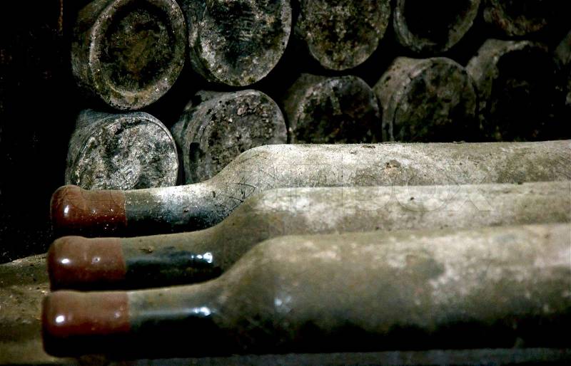 Old wine bottles covered with dust, stock photo