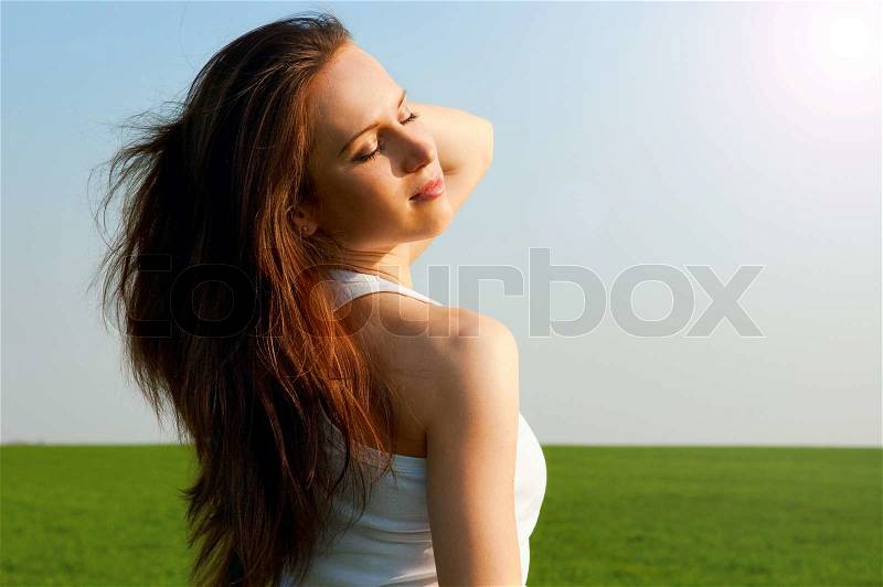 Happy woman relaxation under spring sun, stock photo