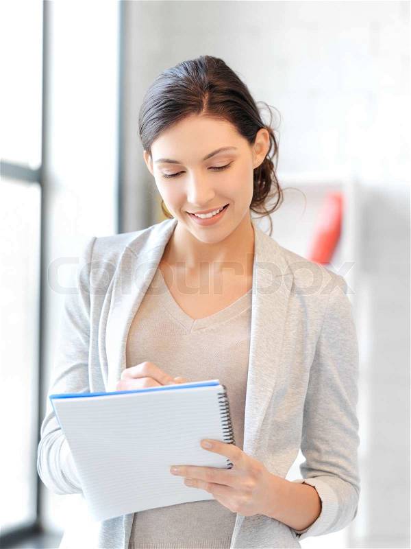 Happy woman with big notepad, stock photo