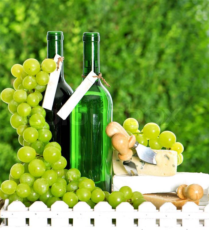 Bottle of wine, cheese and grapes, stock photo