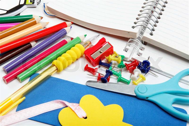School supplies: notebook, pens, pencils on a white background, stock photo