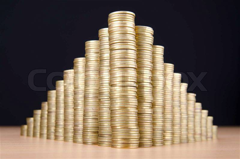 Golden coins in high stacks, stock photo