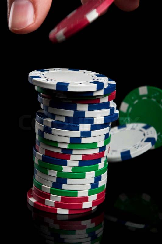 Hand with poker chips, stock photo
