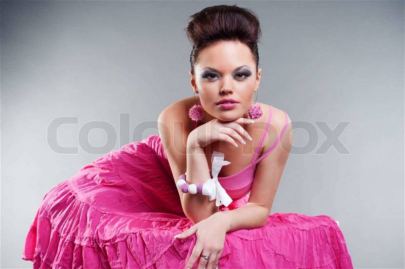 Beautiful brunette in pink dress, stock photo