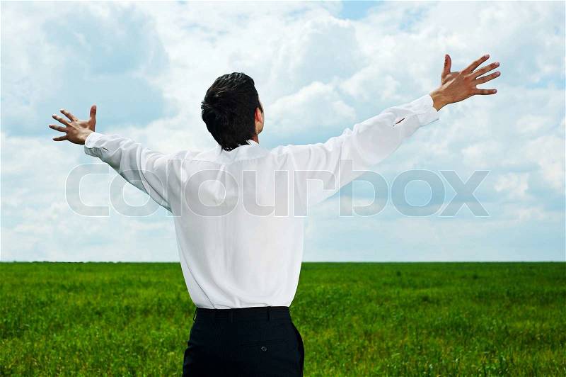 Businessman looking at the sky, stock photo