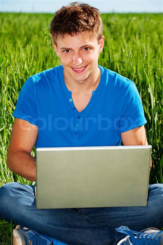 Smiley guy with computer, stock photo