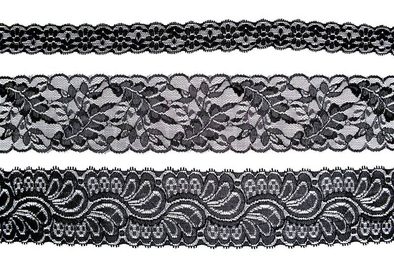 Black lace with pattern in the manner of flower on white background, stock photo