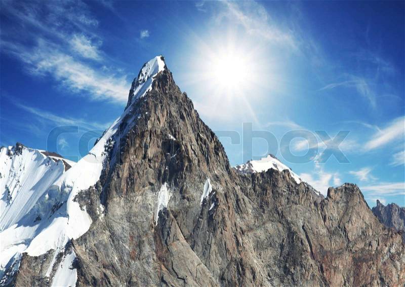 Sun and snow in mountain, stock photo