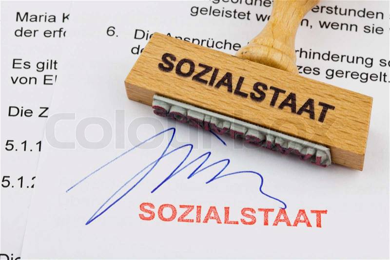 Wood stamp on the document: the welfare state, stock photo