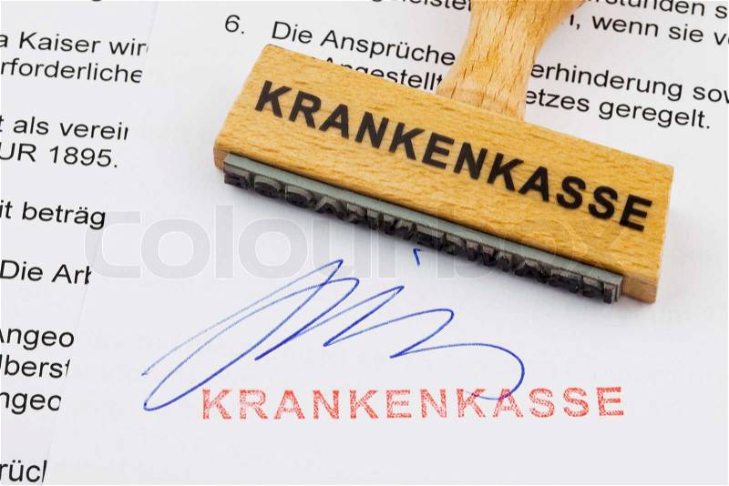 Wood stamp on the document: health insurance, stock photo