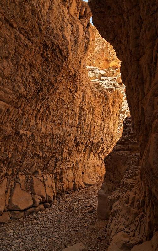 Narrow slot between two rocks in desert canyon, stock photo