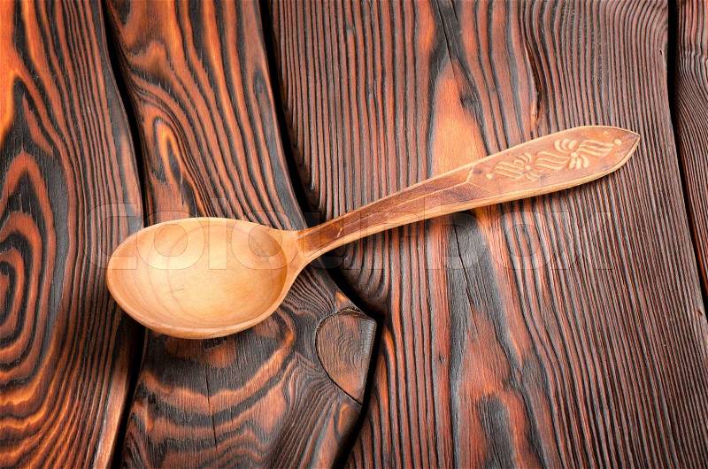 Wooden spoon on the wooden background, stock photo