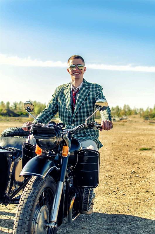 Classy guy on a motorcycle with a sidecar, stock photo