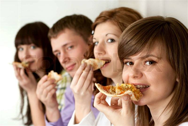 Happy funny Caucasian campaign of four people eating pizza, stock photo