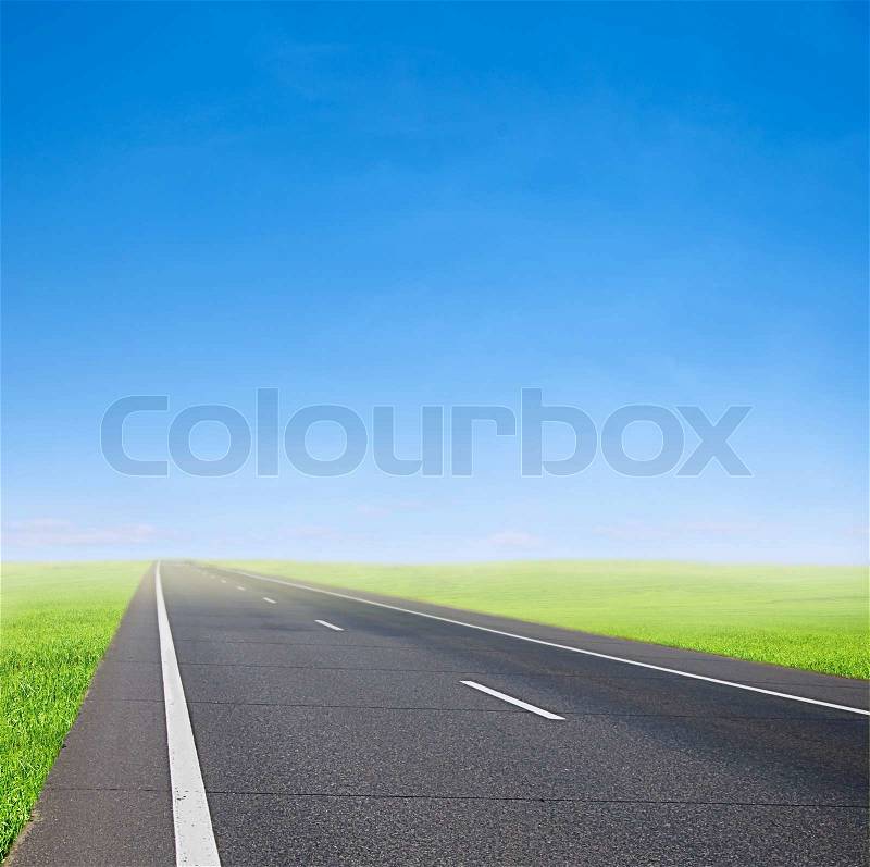 Green field and car road over blue sky - speed and travel, stock photo