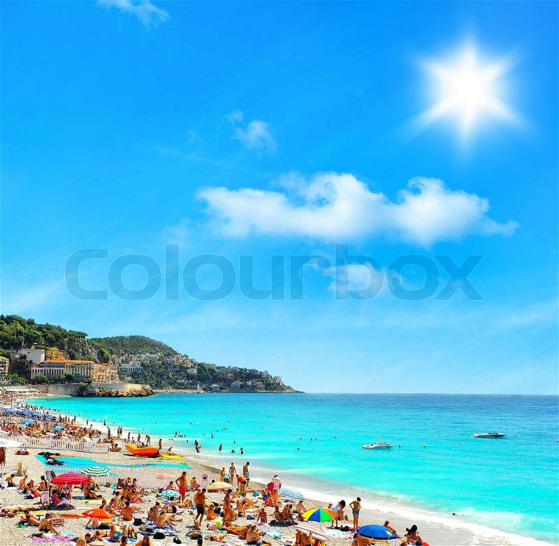 Tourists, sunbeds and umbrellas on sunny hot day, stock photo